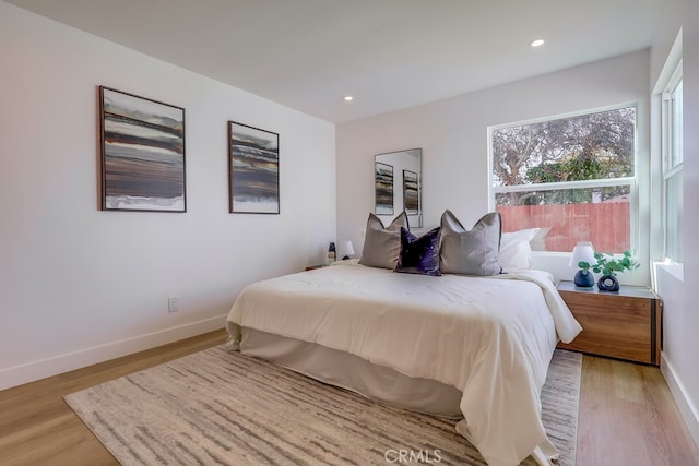 bedroom featuring light wood-type flooring, baseboards, and recessed lighting