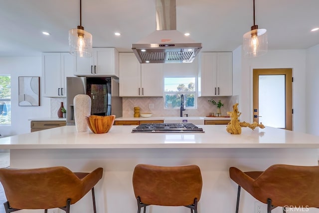 kitchen featuring light countertops, a large island, white cabinets, and island range hood