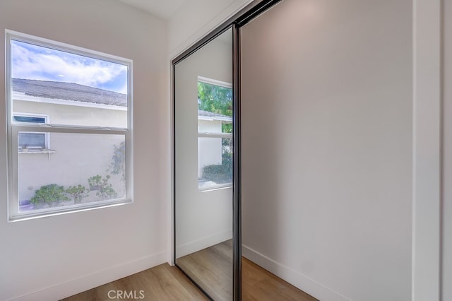 entryway featuring baseboards and wood finished floors