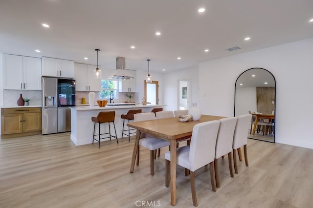 dining area featuring light wood-style floors, recessed lighting, and visible vents