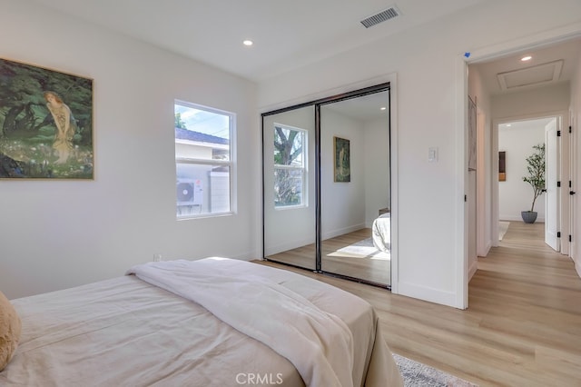 bedroom featuring recessed lighting, a closet, visible vents, light wood-style flooring, and baseboards