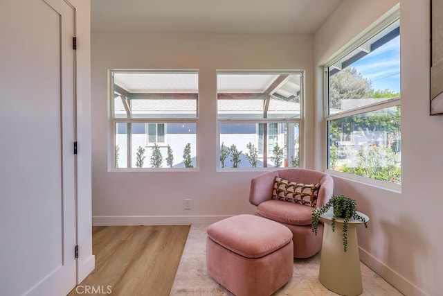 sitting room featuring light wood-style flooring and baseboards