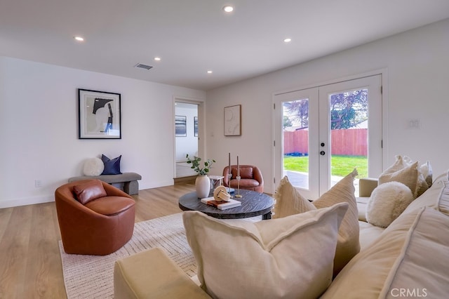 living area with recessed lighting, french doors, visible vents, and light wood-style flooring