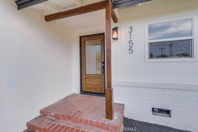 doorway to property with stucco siding