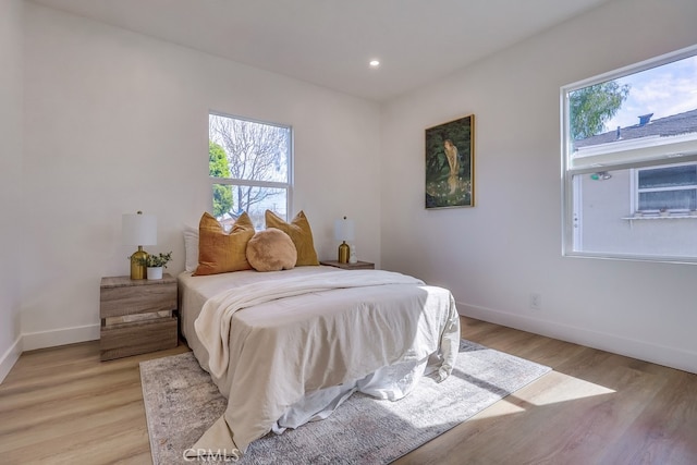 bedroom featuring light wood-type flooring, baseboards, and recessed lighting