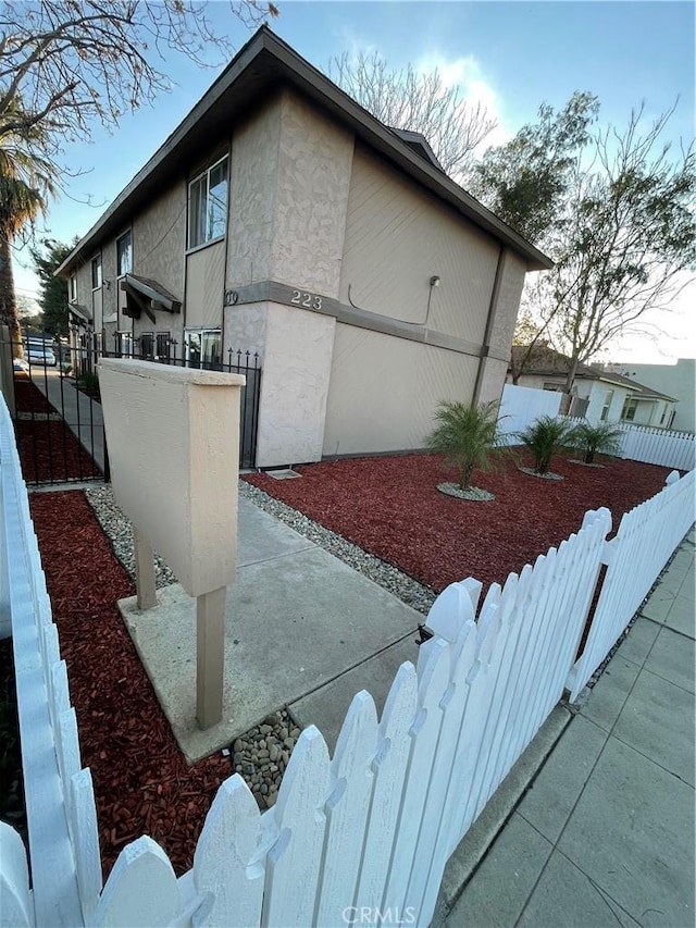 view of home's exterior featuring a fenced front yard and stucco siding
