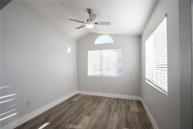 empty room with dark wood-type flooring, lofted ceiling, baseboards, and a ceiling fan