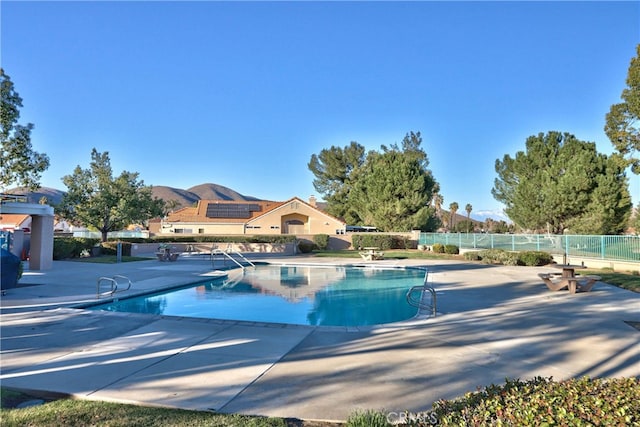 community pool featuring a patio area and fence