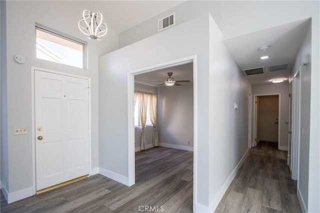 entrance foyer featuring baseboards, visible vents, and dark wood finished floors