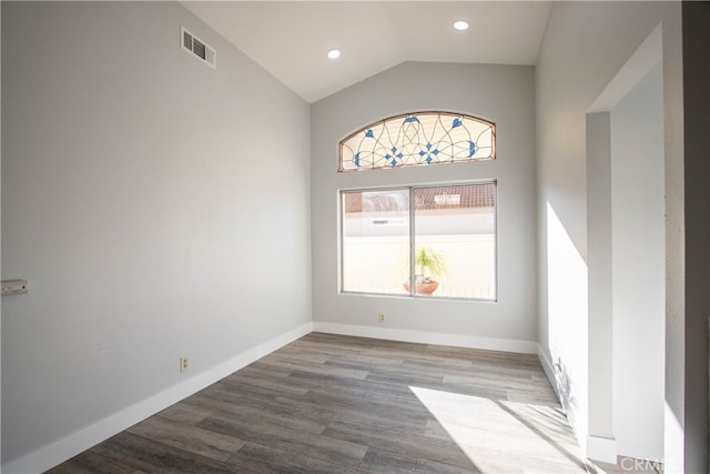 unfurnished room featuring recessed lighting, visible vents, vaulted ceiling, wood finished floors, and baseboards