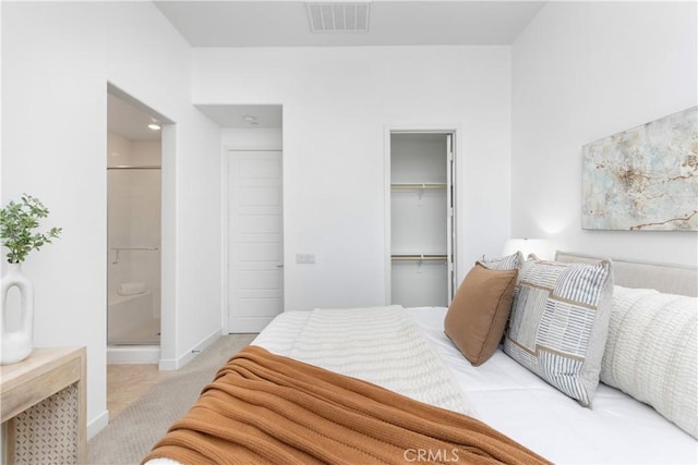 bedroom featuring light carpet, baseboards, visible vents, a spacious closet, and a closet