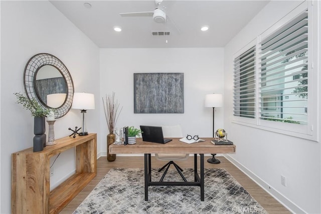 office featuring recessed lighting, visible vents, ceiling fan, wood finished floors, and baseboards