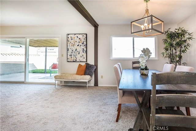 carpeted dining room featuring a chandelier, plenty of natural light, beamed ceiling, and baseboards