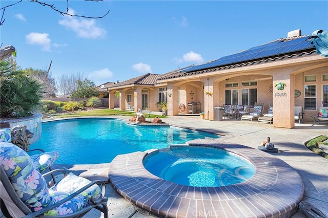 view of swimming pool with a pool with connected hot tub and a patio