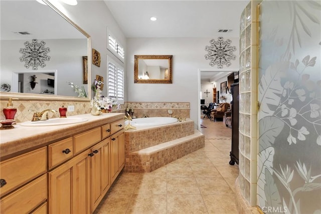 full bathroom featuring visible vents, a garden tub, vanity, and tile patterned floors