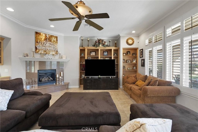 living area featuring light tile patterned floors, ceiling fan, recessed lighting, ornamental molding, and a tiled fireplace