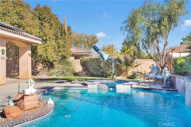 view of pool featuring a fenced backyard and a pool with connected hot tub