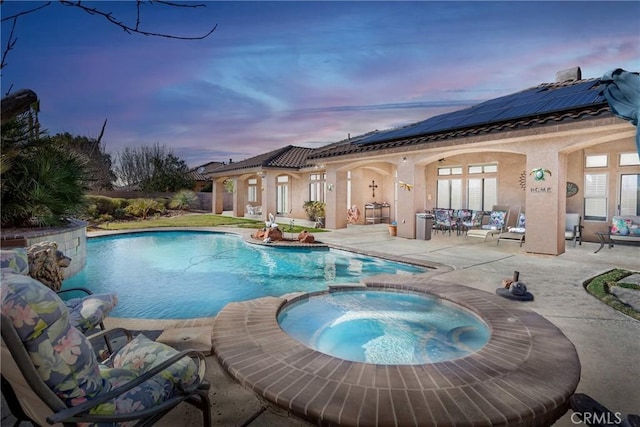 view of swimming pool with a patio and a pool with connected hot tub