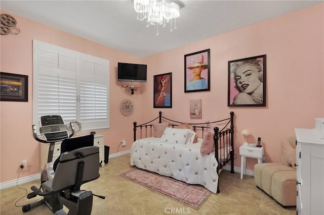 bedroom with baseboards and a notable chandelier