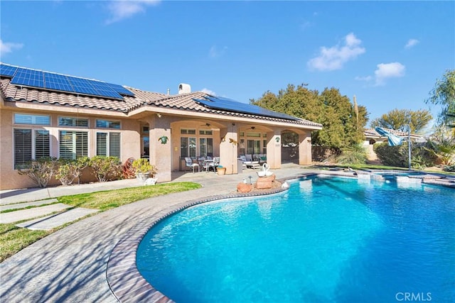 pool with a patio area and ceiling fan