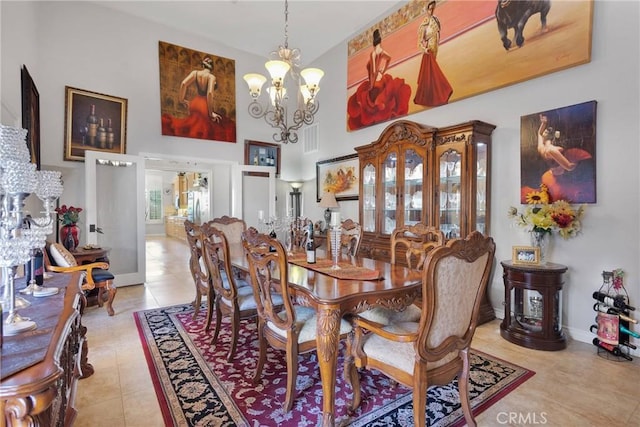 dining area with baseboards, light tile patterned flooring, a towering ceiling, and a notable chandelier