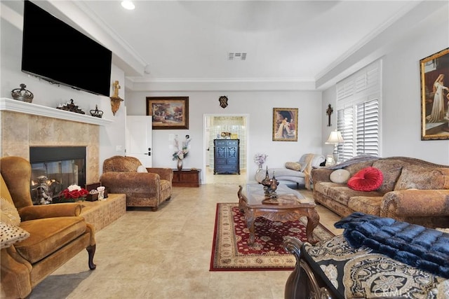 living room featuring a fireplace, visible vents, and crown molding