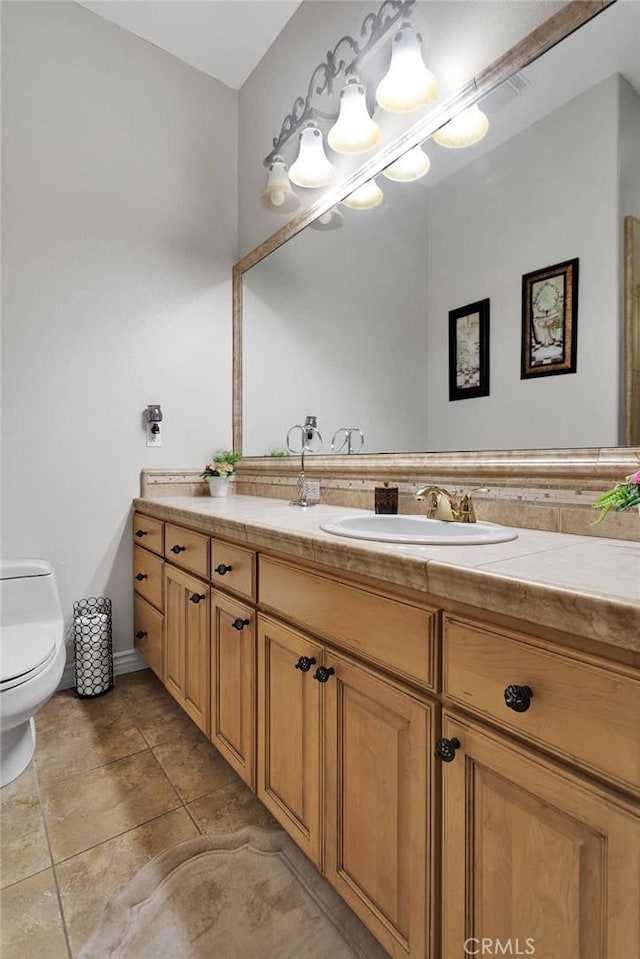 bathroom with toilet and vanity