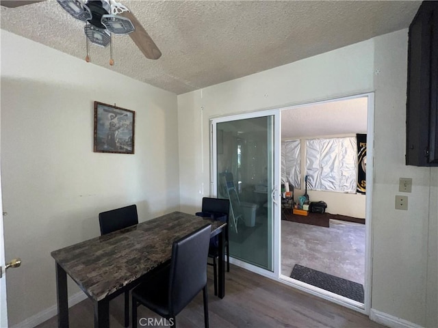 office featuring dark wood-style floors, ceiling fan, baseboards, and a textured ceiling