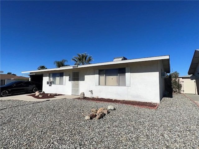 ranch-style home featuring stucco siding