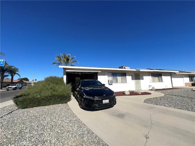 view of front facade featuring concrete driveway and an attached garage