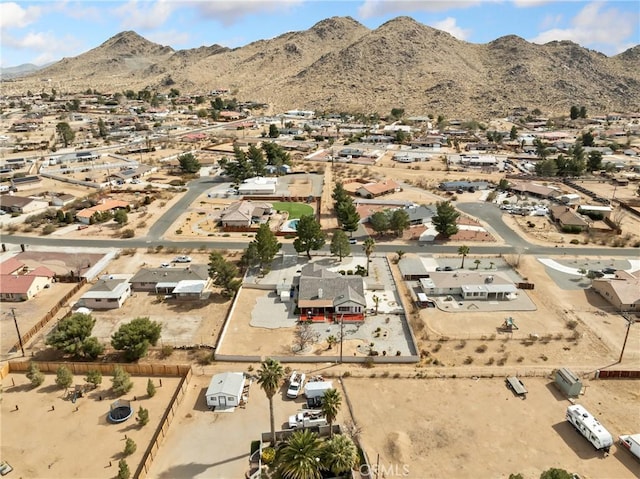 birds eye view of property with a mountain view