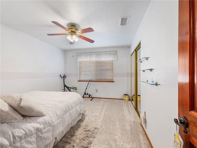 carpeted bedroom featuring a ceiling fan, a closet, visible vents, and baseboards