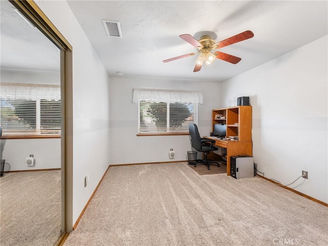 office with baseboards, a ceiling fan, visible vents, and light colored carpet