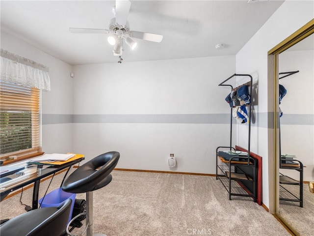 office area with light carpet, baseboards, and a ceiling fan