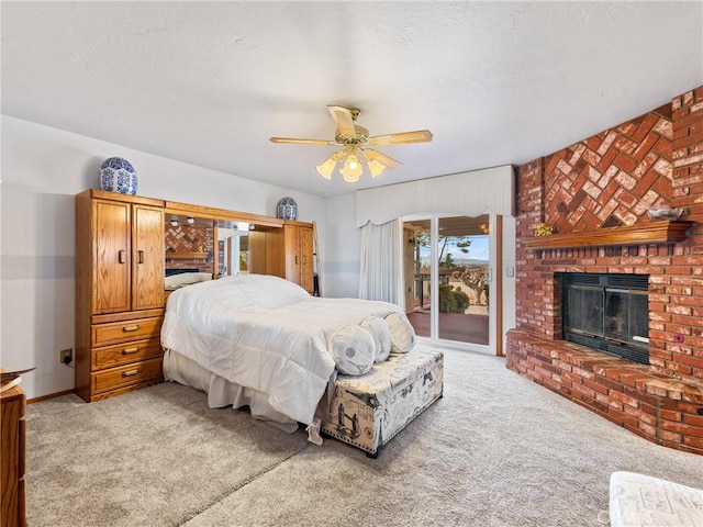 bedroom with light carpet, a brick fireplace, a ceiling fan, and access to exterior