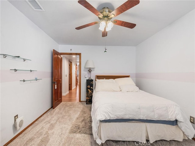 bedroom with light carpet, baseboards, visible vents, and a ceiling fan