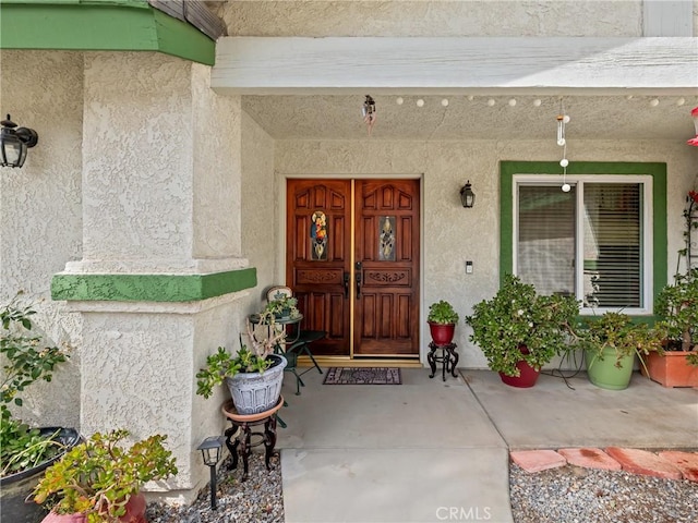 property entrance featuring stucco siding