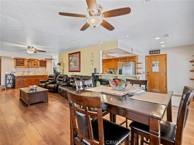 dining space with recessed lighting, visible vents, and light wood finished floors