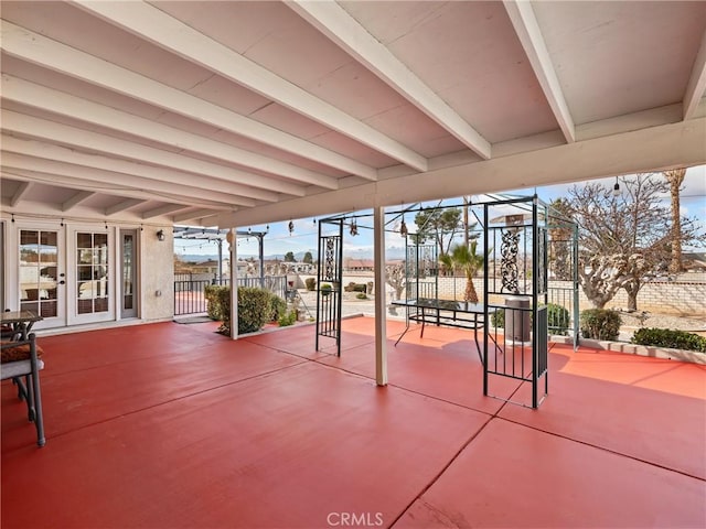 view of patio / terrace featuring fence and french doors