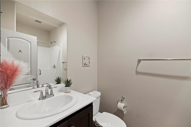 full bathroom with toilet, visible vents, a shower, and vanity