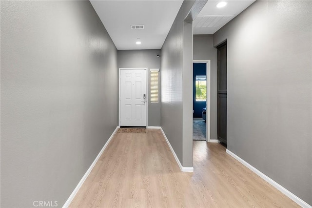 entryway featuring light wood-type flooring, visible vents, and baseboards