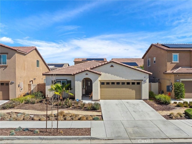 mediterranean / spanish home featuring driveway, a tile roof, a garage, and stucco siding