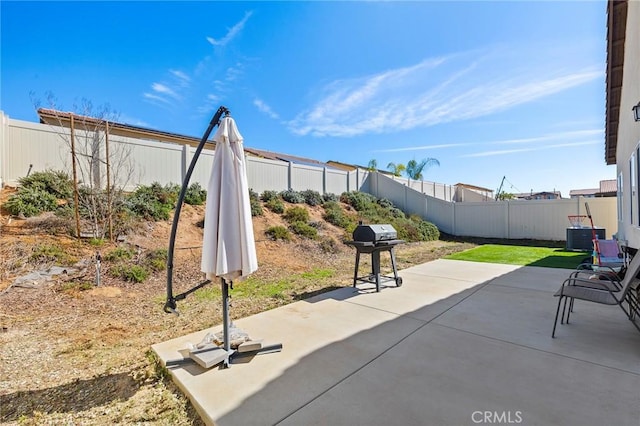 view of patio / terrace with a fenced backyard, central AC unit, and grilling area