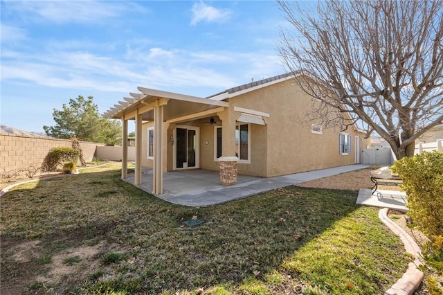 rear view of property with a patio, a yard, a fenced backyard, and stucco siding