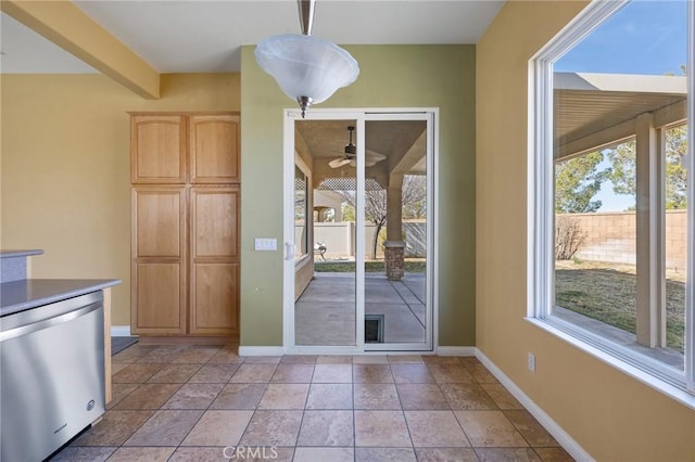 interior space featuring a ceiling fan, beam ceiling, and baseboards