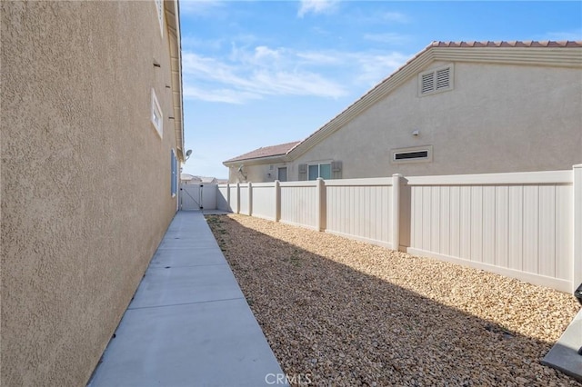 exterior space with fence and stucco siding