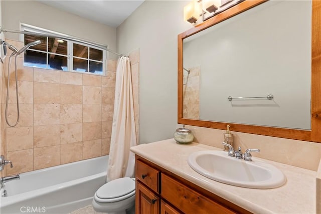 bathroom featuring shower / tub combo with curtain, vanity, and toilet