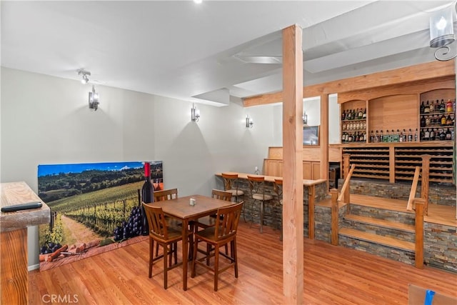 dining room with a dry bar and wood finished floors