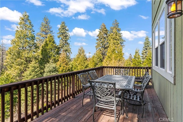 wooden terrace featuring outdoor dining space