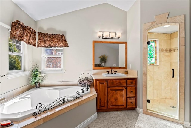 full bathroom with a stall shower, vaulted ceiling, vanity, and a bath